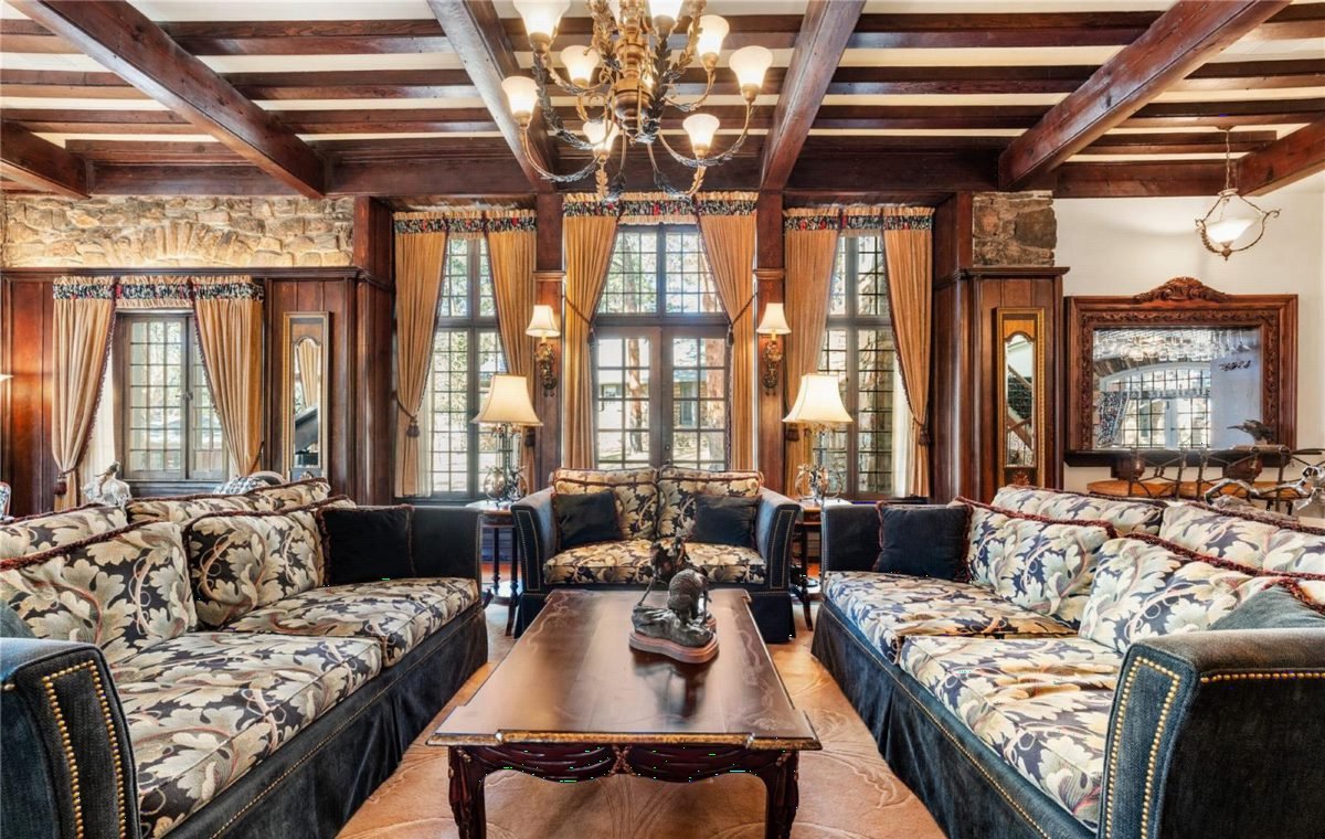 Rich Walnut Beams and Floral Sofas
