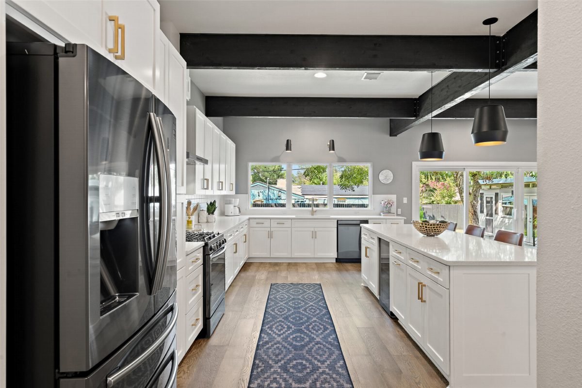 Sleek White Kitchen with Black Beams