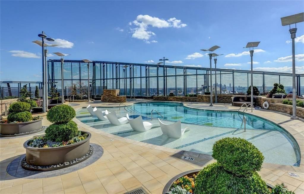 Glass-Walled Rooftop Pool Escape